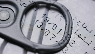 Food date label viewed through a magnifying glass